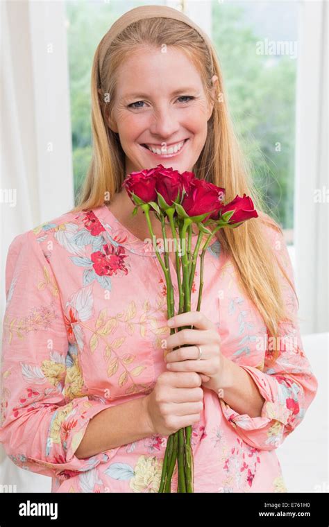 Happy woman holding red roses Stock Photo - Alamy