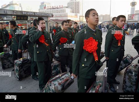 Chinese demobilized soldiers wait to take the train at a railway station in Beijing, China. 04 ...