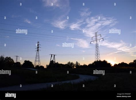 Electric poles on sunset Stock Photo - Alamy