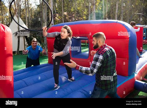 People passing obstacles on inflatable arena at amusement park Stock Photo - Alamy