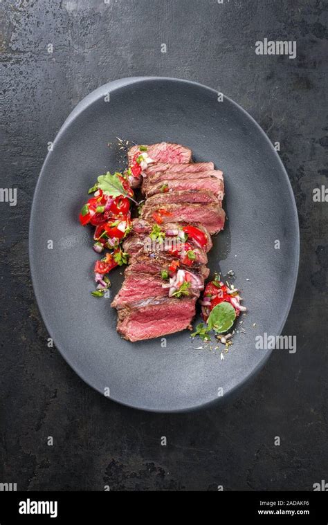 Traditional South American barbecue wagyu roast beef sliced with pico de gallo and salsa verde ...