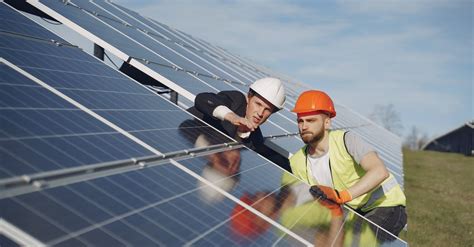 Men discussing solar panels installation in field · Free Stock Photo
