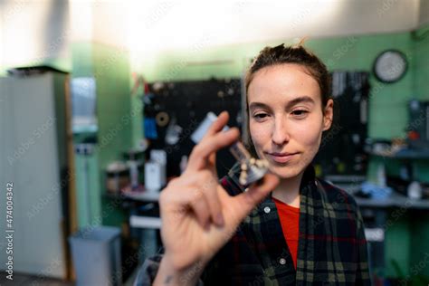 Female mechanic examining vehicle equipment at workshop Stock Photo ...