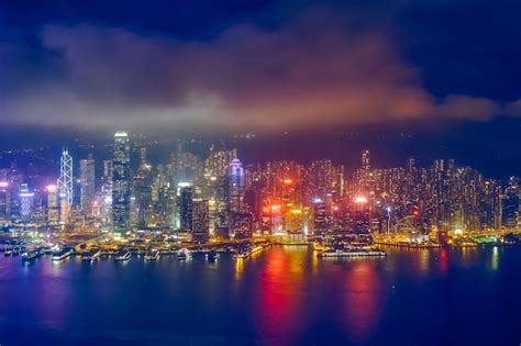 Premium Photo | Aerial view of illuminated Hong Kong skyline. Hong Kong ...