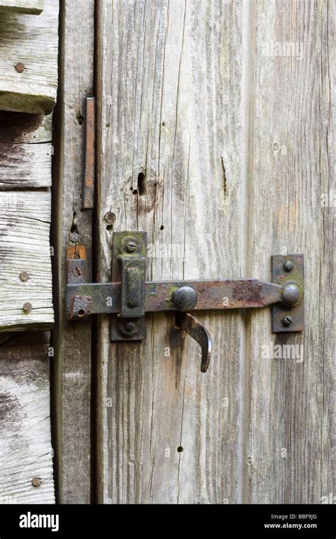 Latch and lock on old shed door Stock Photo - Alamy