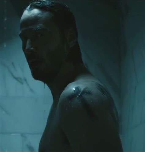 John Wick (2014) with Keanu Reeves, left shoulder tattoo of a cross