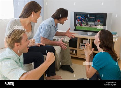 Friends watching baseball game and cheering Stock Photo - Alamy