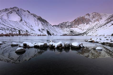 Winter sunrise reflection at Convict Lake in the Eastern Sierras of ...