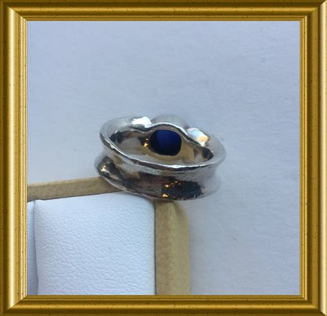 Silver ring with blue cabochon sapphire stone