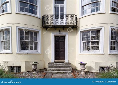 The Entrance To a Large Victorian House with Bay Windows Either Side of ...