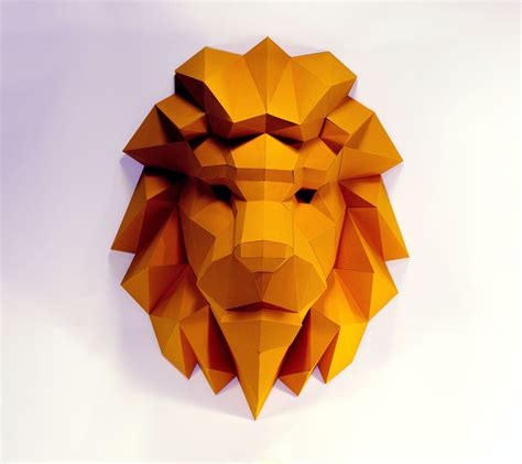 a paper sculpture of a lion's head made out of yellow origami