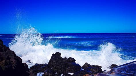 Download 1366x768 wallpaper coastal, rocks, sea waves, blue sea, tablet, laptop, 1366x768 hd ...