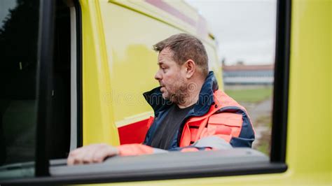 Rescuer Getting in To Ambulance Car, Preparing for Rescue Operation ...