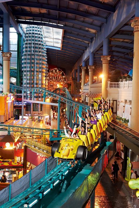 a roller coaster ride in the middle of an indoor mall with people ...