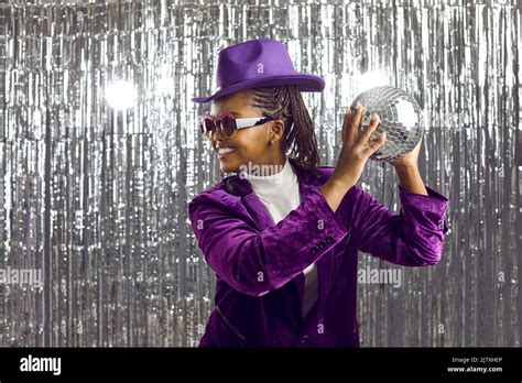 Happy black woman in costume hold disco ball Stock Photo - Alamy