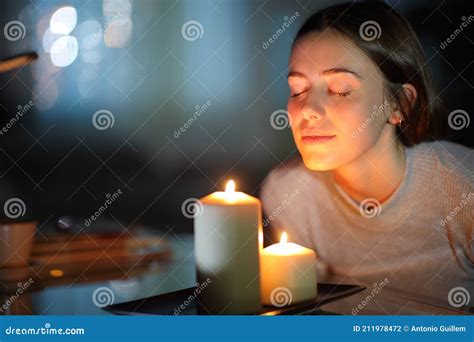 Woman Smelling a Lighted Candle in the Night Stock Photo - Image of female, breathe: 211978472