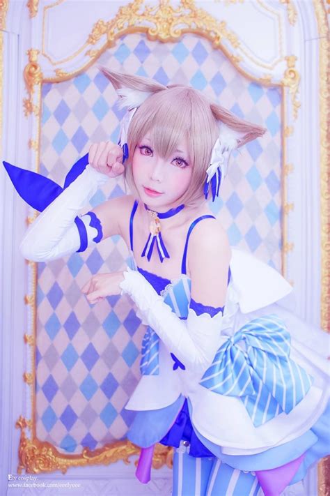 a woman dressed in blue and white poses for the camera