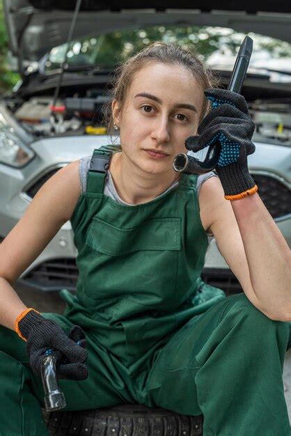 Premium Photo | Young skilled specialist mechanic woman in overalls and ...