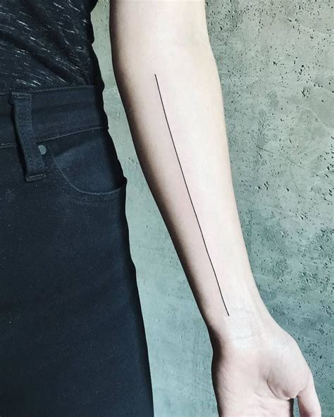 Black thin long line tattoo on the arm - Tattoogrid.net