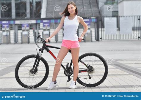 Beautiful Girl Riding a Bicycle in a City. Standing with Bike. Active ...