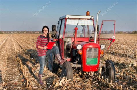 Woman with tractor on the field — Stock Photo © budabar #88475008