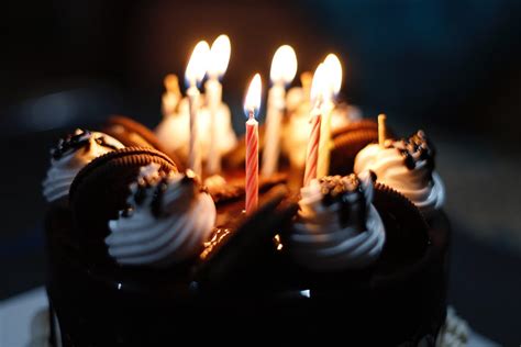 A Close-Up Shot of a Chocolate Cake with Lighted Candles · Free Stock Photo