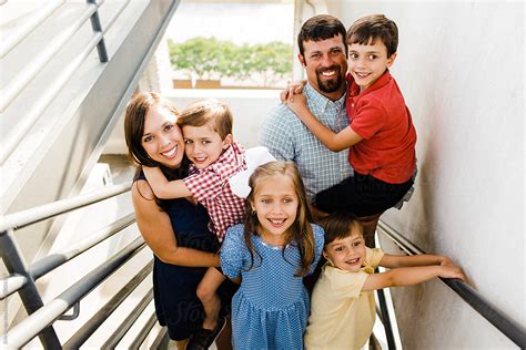 "Happy Family Of 6 Standing Together" by Stocksy Contributor "Erin Drago" - Stocksy