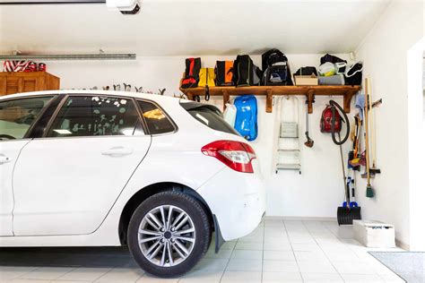 Home suburban car garage interior with wooden shelf , tools and equipment stuff storage ...