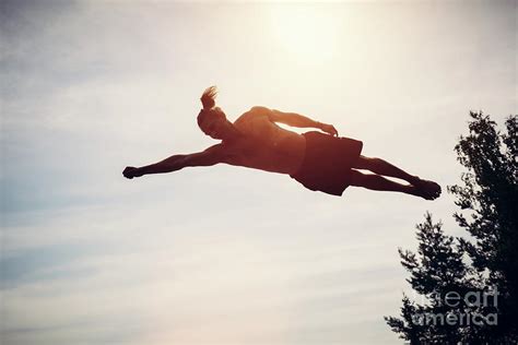 Young man levitating in the air. Photograph by Michal Bednarek - Fine Art America