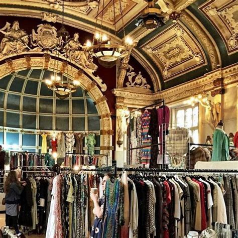 a large room filled with lots of clothes and chandelier hanging from ...