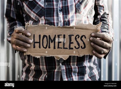 Homeless man holding sign Stock Photo - Alamy