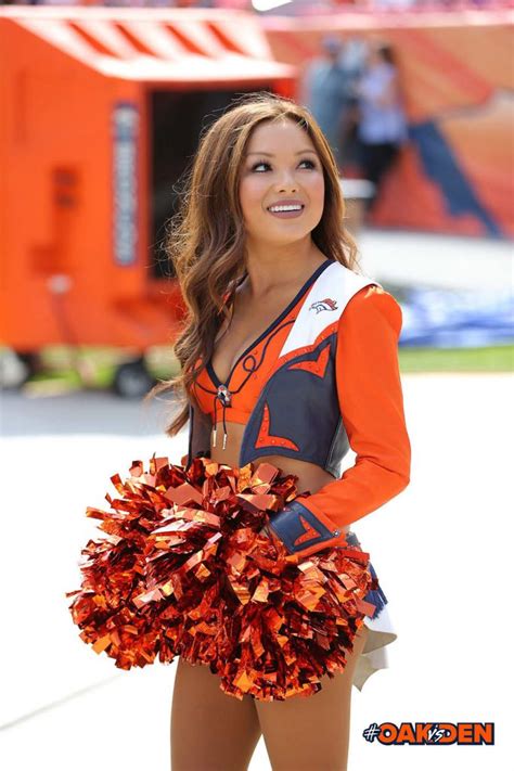 a cheerleader in an orange and black uniform