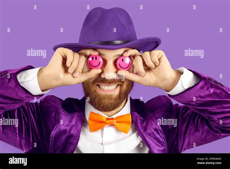 Funny bearded guy in a hat, suit and bow tie covering his eyes with two smiley emojis Stock ...