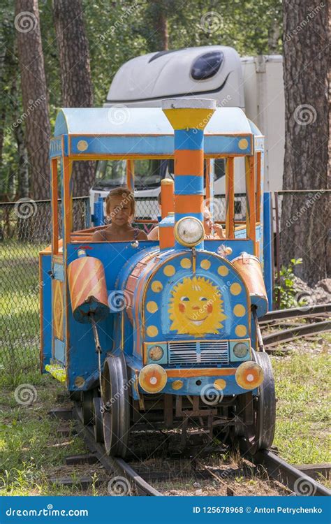 Children are Riding on a Children& X27;s Train in the Park. Vertical ...