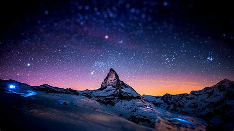 Snowy mountain backdropped by a beautiful star-filled sky, wilderness ...