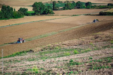 Tractor plowing field Stock Photo | Adobe Stock