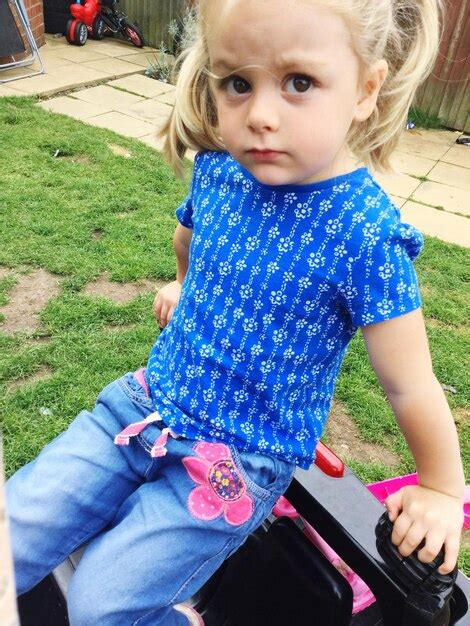 Premium Photo | High angle view of cute girl sitting on toy car at back yard