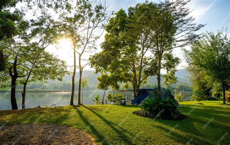 Premium Photo | Camping and tent in nature park with sunset