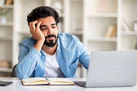 Premium Photo | Monotonous work indian freelancer guy working on laptop at home office