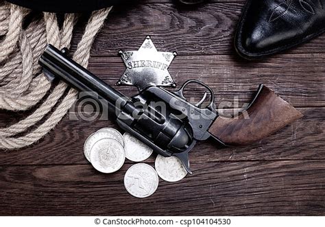 Old west law enforcement - revolver guns with sheriff badge and silver ...