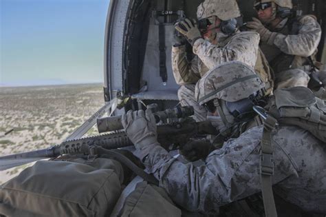 A U.S. Marine Corps Scout Sniper prepares to fire a M110 SASS rifle ...