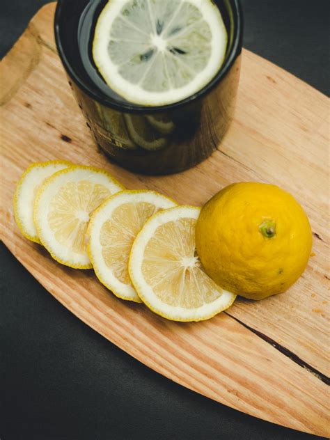 Sliced Lemon and Black Mug on Wooden Cutting Board · Free Stock Photo