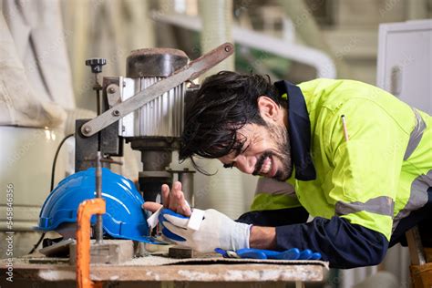 Engineer men wearing uniform accident on machines from work in lathe factory. health and safety ...