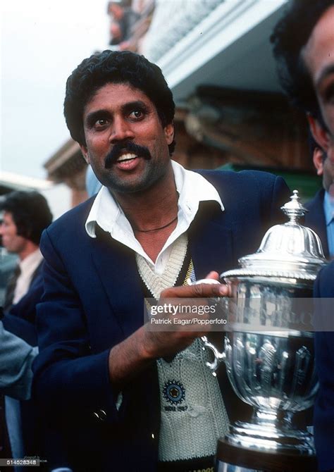 India captain Kapil Dev holds the trophy after the World Cup Final...