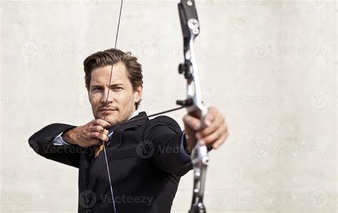 Businessman aiming bow and arrow 874752 Stock Photo at Vecteezy