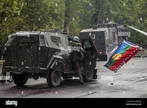 Santiago, Chile. 11 November 2019. Mapuche flag and car spear gas. With a massive march of ...