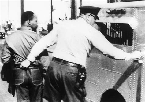 (Original Caption) 4/12/1963-Birmingham, AL: A police officer grabs ...