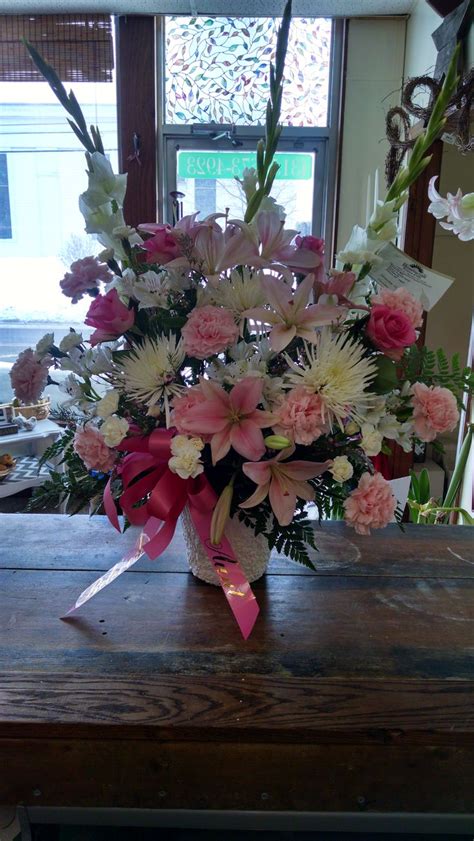 This sympathy arrangement contains pink lilies, white gladiolus, white ...