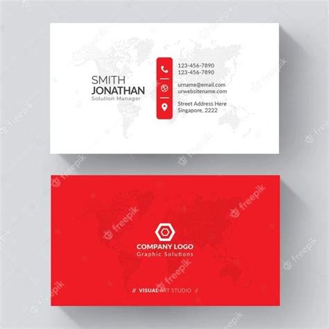 a red and white business card with a world map in the background, on a gray surface