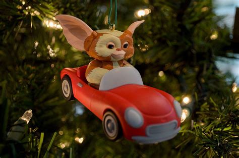 an ornament hanging from a christmas tree in the shape of a dog driving ...